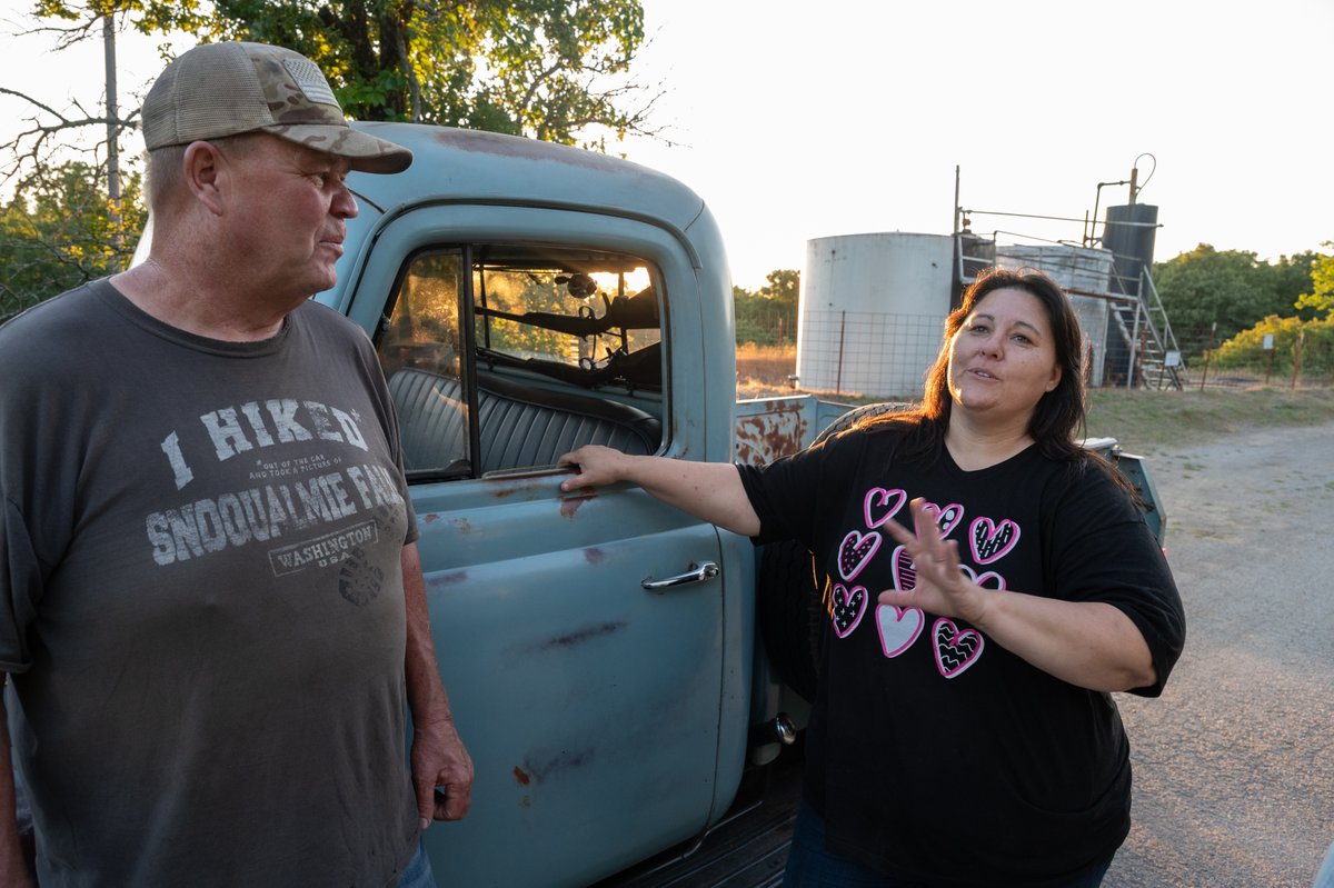 @zdroberts @dbambrose Chris (left), a member of the Cherokee nation, and his partner Jennifer explain how the pump jack delivers oil from the ground to the tank battery (behind them) from which companies like #KochOil would measure and remove the oil.