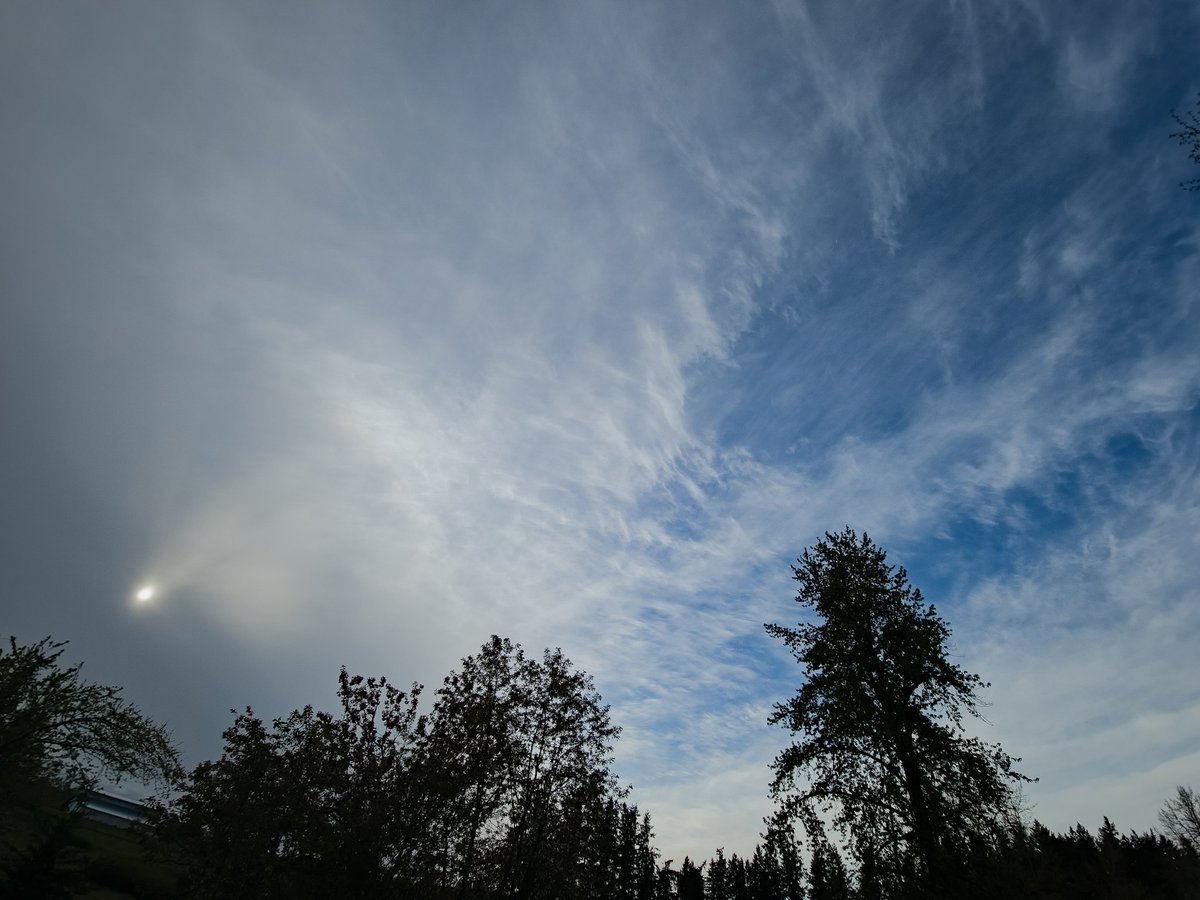 Blue sky chased by thick gray clouds swallowing the sun.