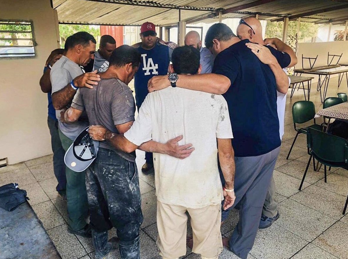 These Christians are praying during a celebration at which more than 100 new believers received baptism. 'In the middle of threats, the church in Cuba continues,' said a front-line worker who ministers in the country.