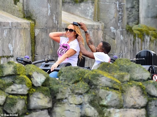 Mariah Carey getting her hair fixed on a roller coaster