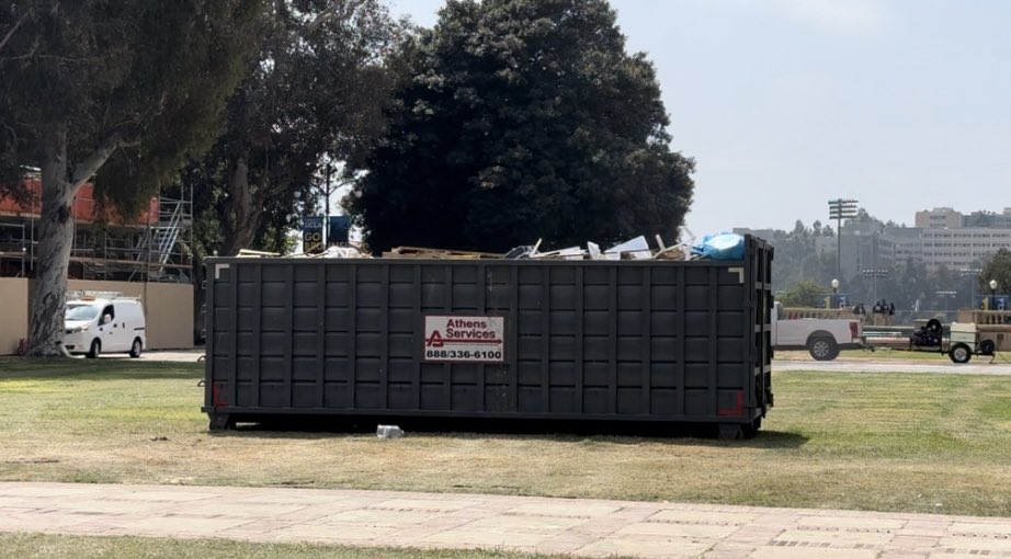 Protester Ren Diaz, who was arrested this morning, just showed back up at @UCLA trying to get his wallet, keys & Apple Watch that he left at the encampment. He says his air tag shows they’re inside this dumpster at Dickson Plaza, but the university is no longer allowing access