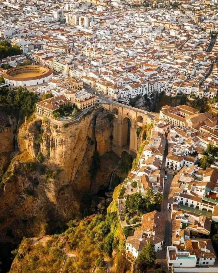 Ronda is an ancient town perched on a deep gorge in Malaga, Spain Puente Nuevo is a bridge that spans the 'el Tajo' ravine and the Guadalevín River, joining the two ends of the city With a height of 98 meters, the Puente Nuevo was the tallest bridge in the world until 1839