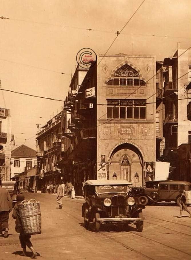 Beirut down from Wigan Street to Bab Idris.
In front of Al-Tarazal Street (Andalusia) next to the entrance of the Al-Afring Market, you can see the beautiful heritage buildings, the small Atala, the cars, & and the tramway railway, 1935 
Ayam Zaman 2