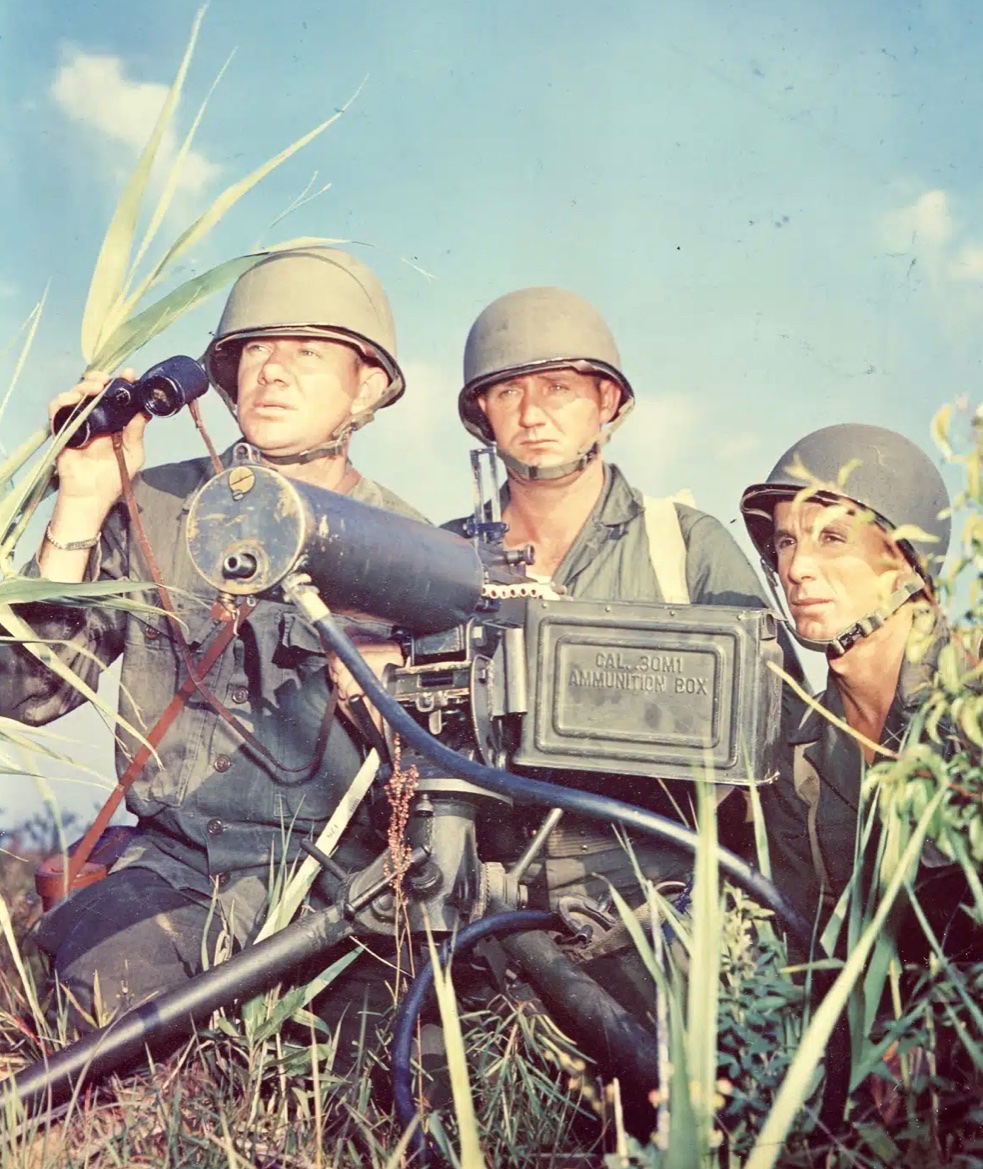 In May of 1945, a Tech Sgt. uses his Westinghouse binoculars to observe “enemy” activities for range on his 30 cal. machine gun during training at Fort Benning, Georgia. 🪖