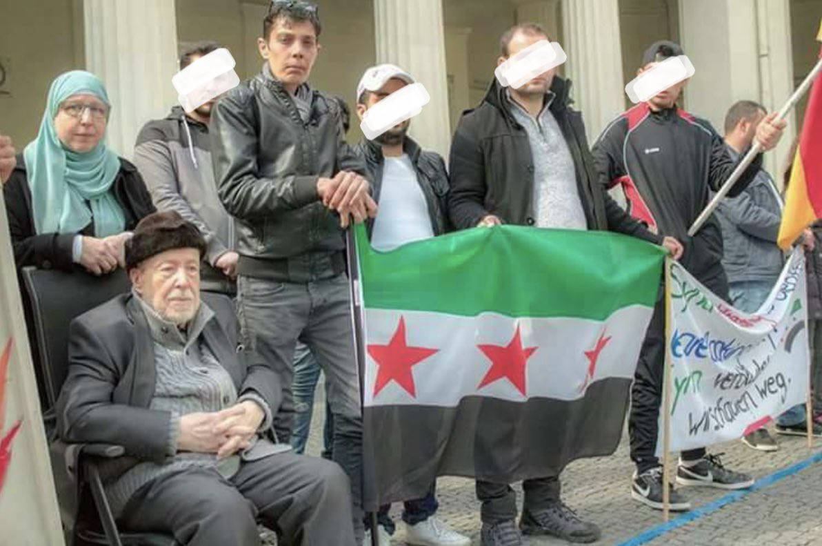 Essam Al Attar, his daughter Hadia Al Attar, Mazen Hamada & others in a protest in Germany against Assad regime; circa 2014-2019. *Hamada has been forcibly disappeared in Syria since Feb 2020. *Al Attar was exiled in 1963 & survived assassination until his passing, today.