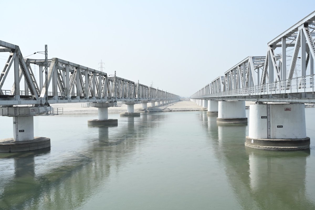 On a bare and tranquil morning, Rail bridge over Teesta river in Jalpaiguri, West Bengal blends with the stillness of the waters.