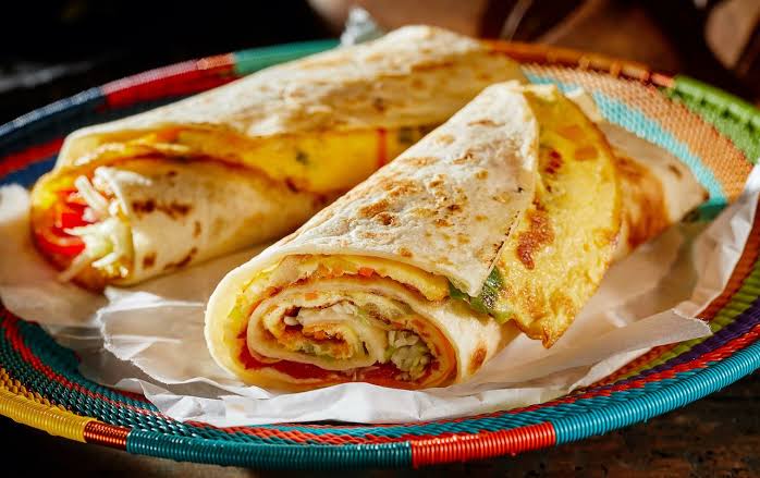 In Uganda, 'Rolex' isn't a watch, but a popular street food! It's a tasty, affordable omelette with veggies like onions, tomatoes, and cabbage, wrapped in a chapati. 

Try it from a street vendor for a local flavor experience 

#RAS24UG 
#Rolex
 #Food
#LeafsForever 
#VisitUganda