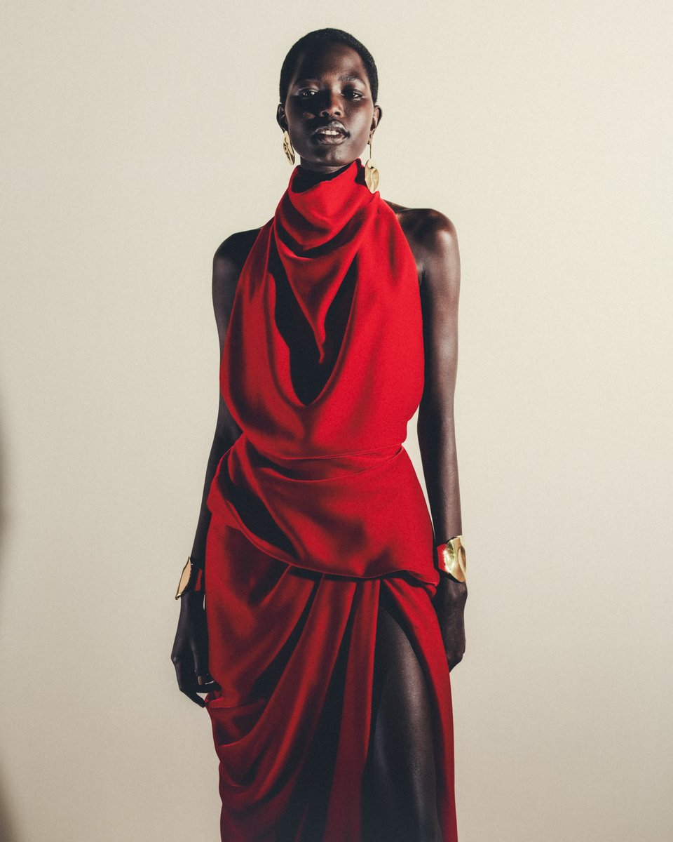 A blood red silk velvet halterneck dress with an asymmetric drape and high side split.

Discover the #McQueenSS24 collection: on.alexandermcqueen.com/SS24_TW