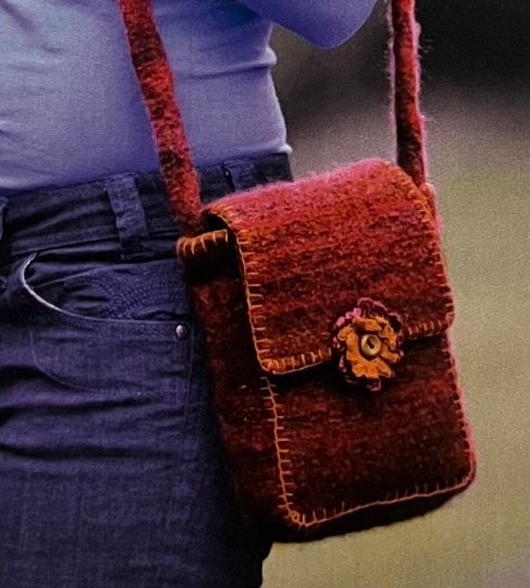 Beautiful Crochet Felted Shoulder Bag 👜 This charming bag combines the artistry of crochet with the cosiness of felted fabric. Blanket stitch edges and a flower motif in contrasting colours. Perfect for adding a touch of handmade #MHHSBD #craftbizparty #elevenseshour