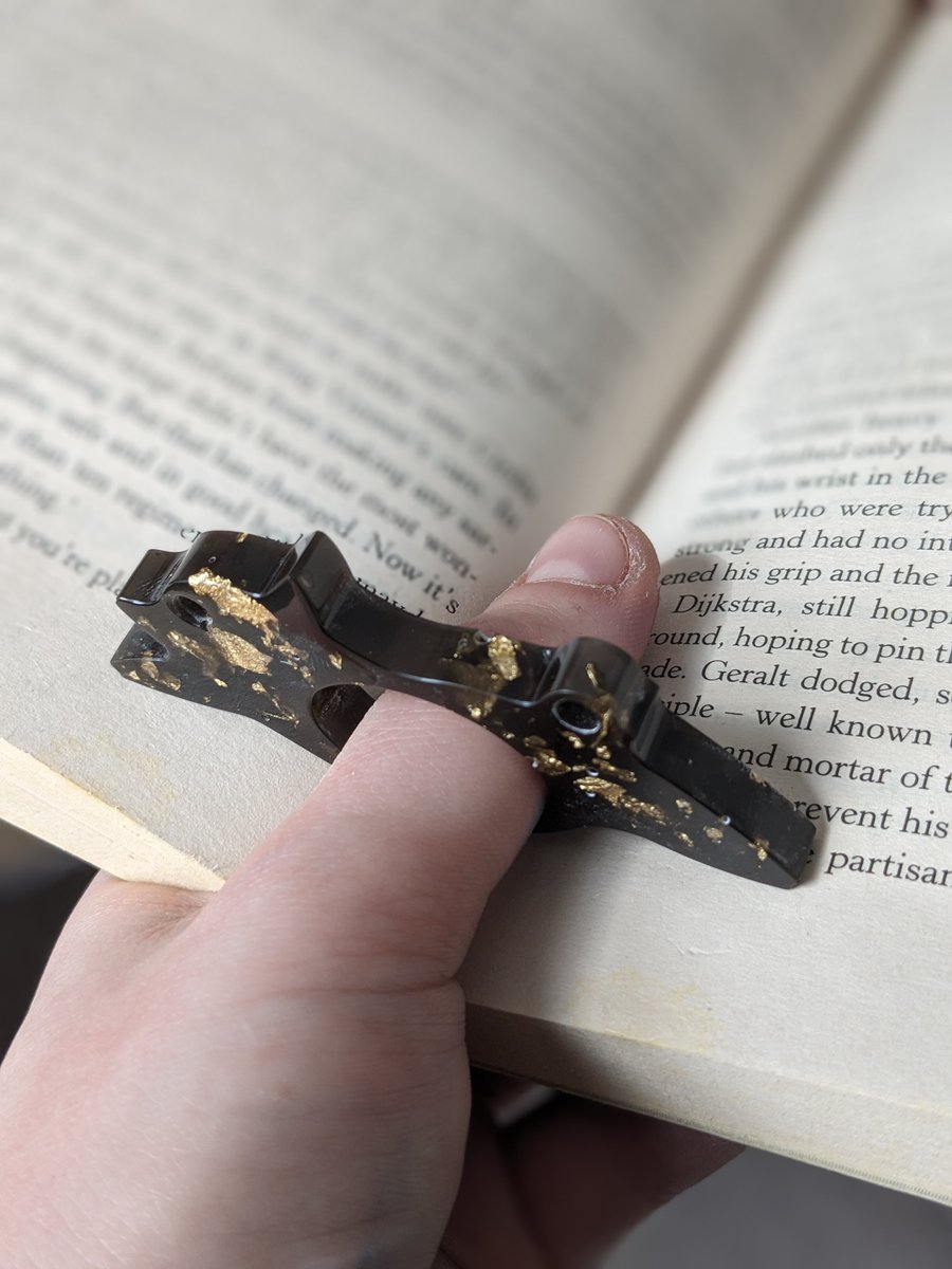 Book Twitter! You need one of these! They help you to read one handed so you can use your other hand to do things that matter; cook, clean and even arson