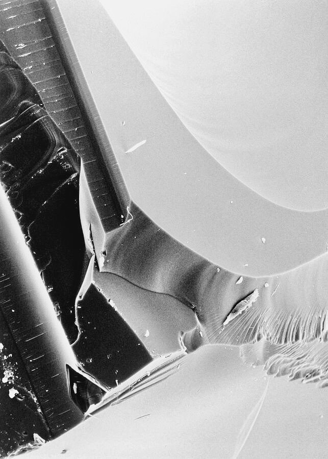 broken edge of a glass under an electron microscope