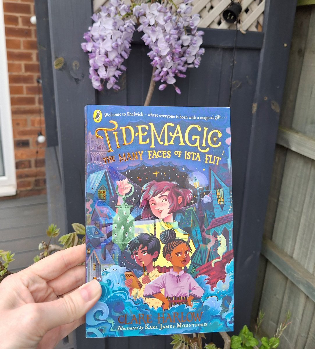 Currently reading Tidemagic - The Many Faces of Ista Flit by @clareharlow and loving it! 😍 (and in other news my wisteria flowered for the first time in 5 years) 🪻