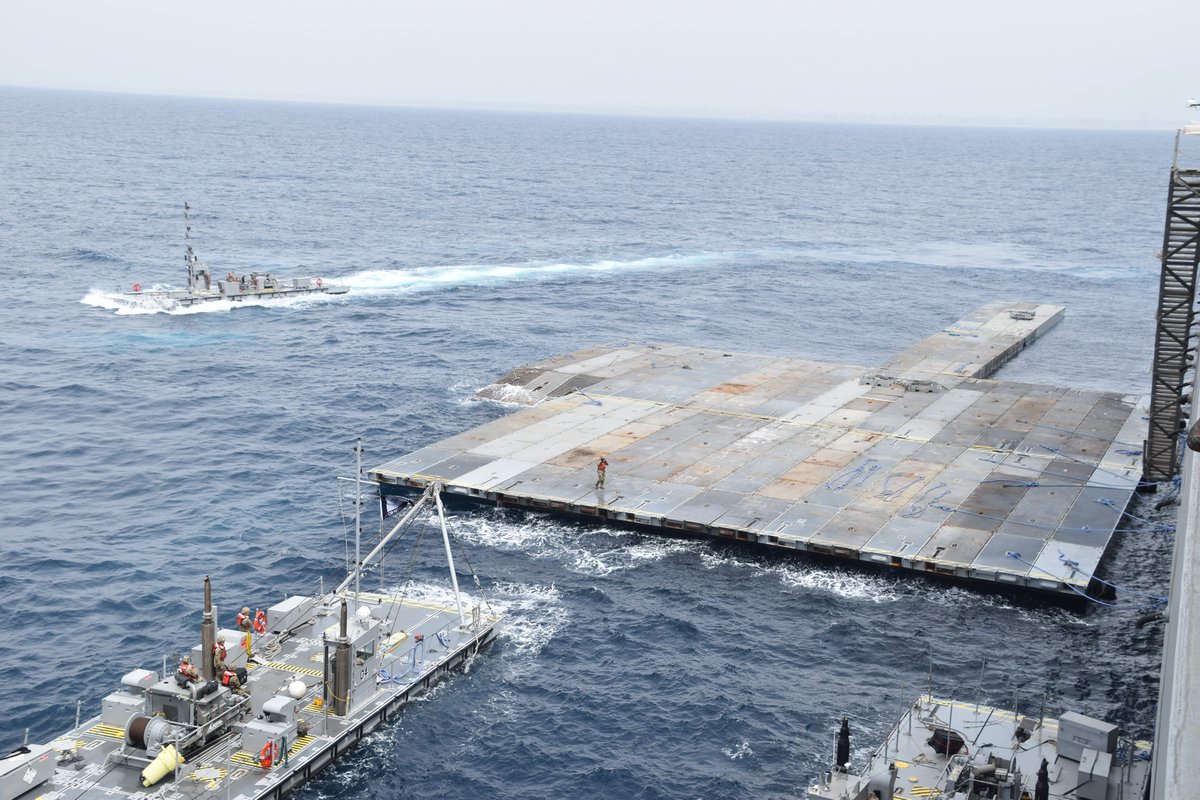 PHOTOS: Construction on the temporary pier to surge humanitarian aid into Gaza. In support of the @USAID-led response, @CENTCOM is building this pier off the coast, and U.S. assistance will arrive here from Cyprus w/ @US_TRANSCOM & @US_EUCOM support before reaching Gazans.