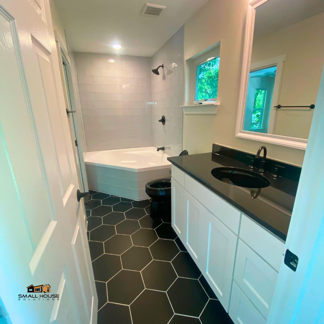 Soak up the serenity 🌿🛁. Gonzales' bathroom boasts a tub to melt away the stress of the day and a mirror to reflect your glow. It's self-care in the form of home design.  buff.ly/3QoZNXj #SmallHouseSolutions #bathroomgoals