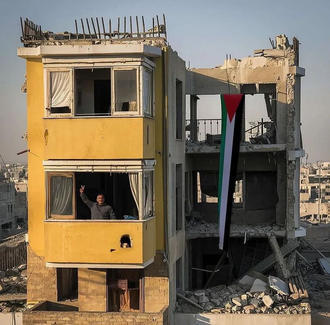 A Palestinian remains resilient in his home despite it being heavily damaged by Israeli occupation bombardment in northern Gaza.