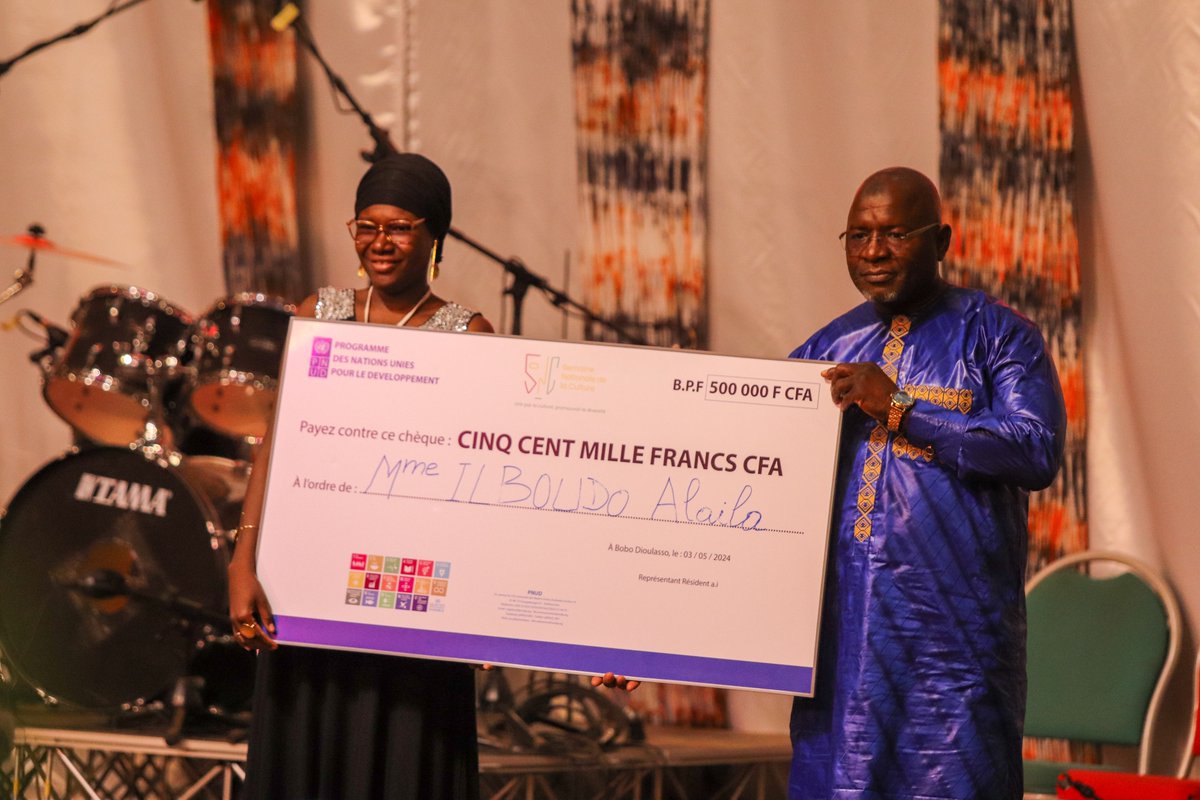 PNUD_BFA's tweet photo. C'est avec de vives émotions que Mme Ilboudo Alaila venant de la Province de l'Oubritenga reçoit son prix de la Meilleure Slameuse au #GPNAL lors de la #SNCBobo2024 décerné par le PNUD 🇧🇫🙌🏾