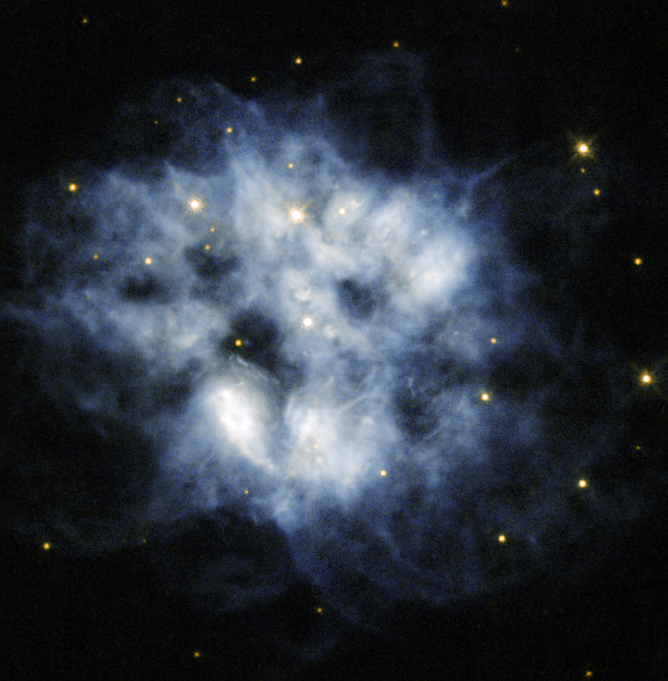 A planetary nebula—like the one shown in this Hubble image—is a region of cosmic gas and dust formed by the cast-off outer layers of a dying star. For NGC 2452, the dying star shining in the center of the blue cloud was once larger than our sun. Credit: ESA/NASA.