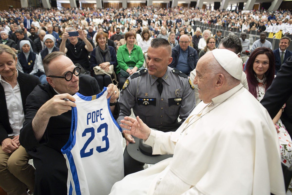 Lexington priest <a href="/JimSichko/">Father Jim Sichko</a> gives the Pope a Pope jersey