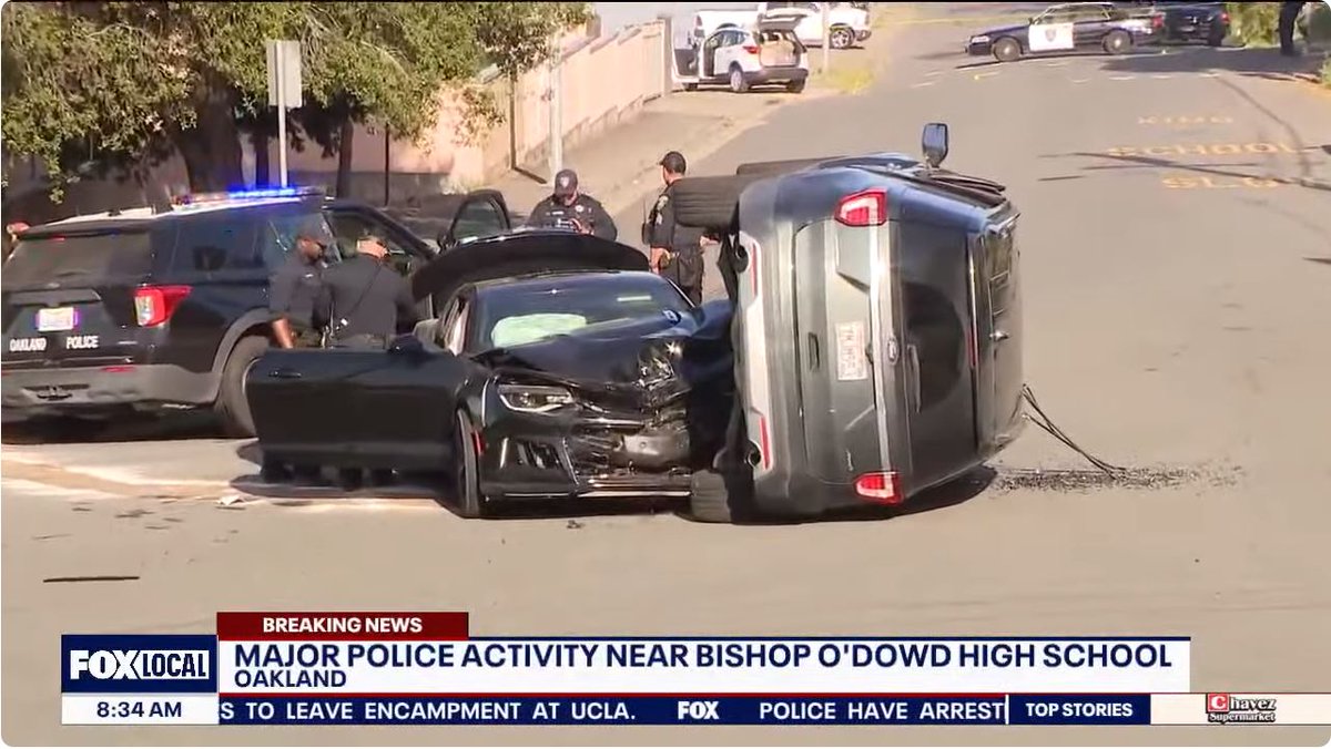 Mad Max style shooting/car crash in Oakland, CA. A mother was trying to drop her daughter off at school when a black sedan came speeding down the road while firing bullets at an unknown target.