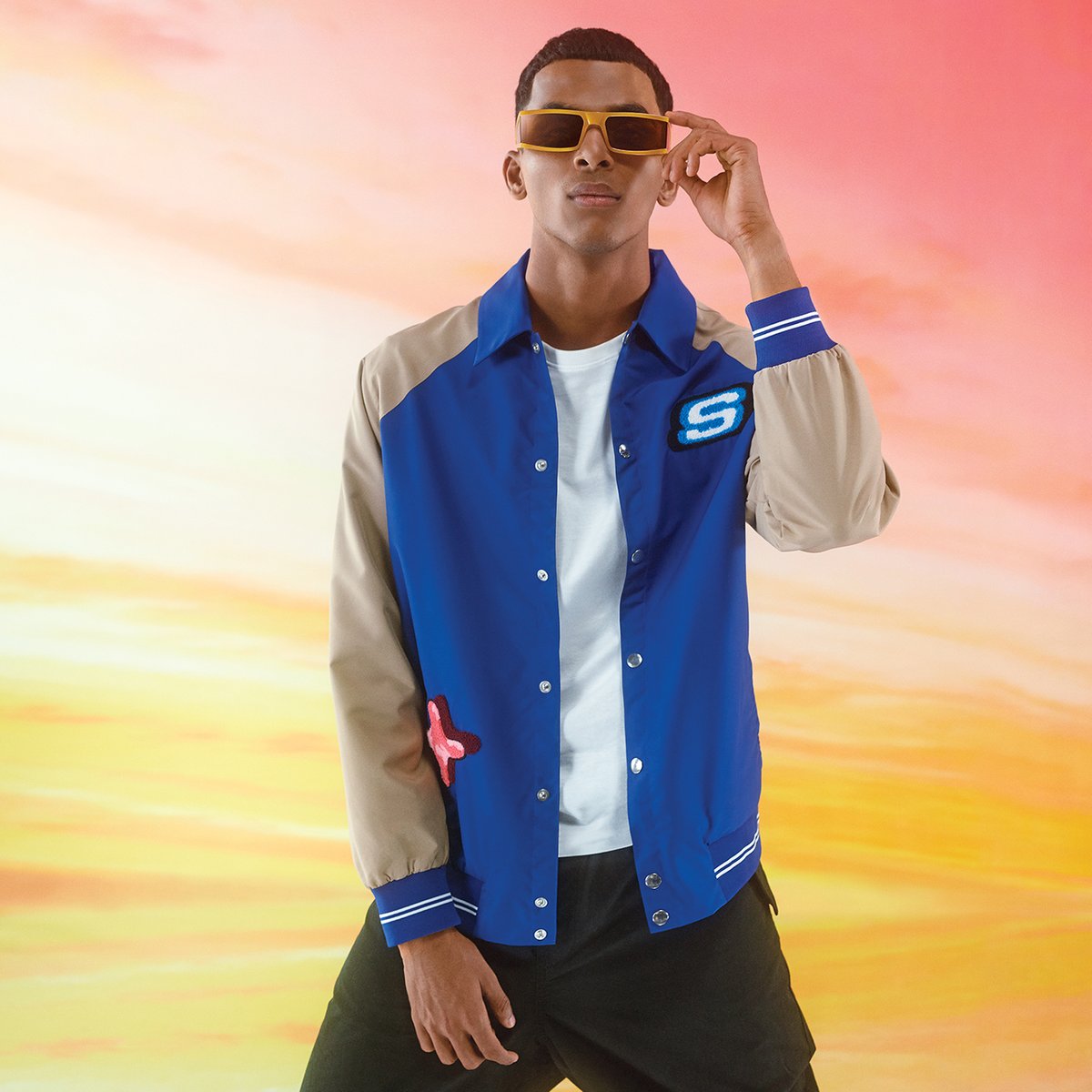 We're going back to the 90s! Shop this timeless varsity jacket from the Skechers #Retroverse Collection. Check out styles from the collection: shorturl.at/ioFW7 #SkechersIndia #Retroverse #90sStyle #LimitedEdition #FashionWeek #RetroStyle #SkechersApparel #StreetStyle