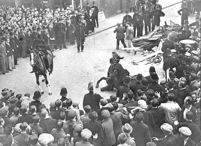 Mounted policeman falls with horse during a demonstration in 1937. >FH