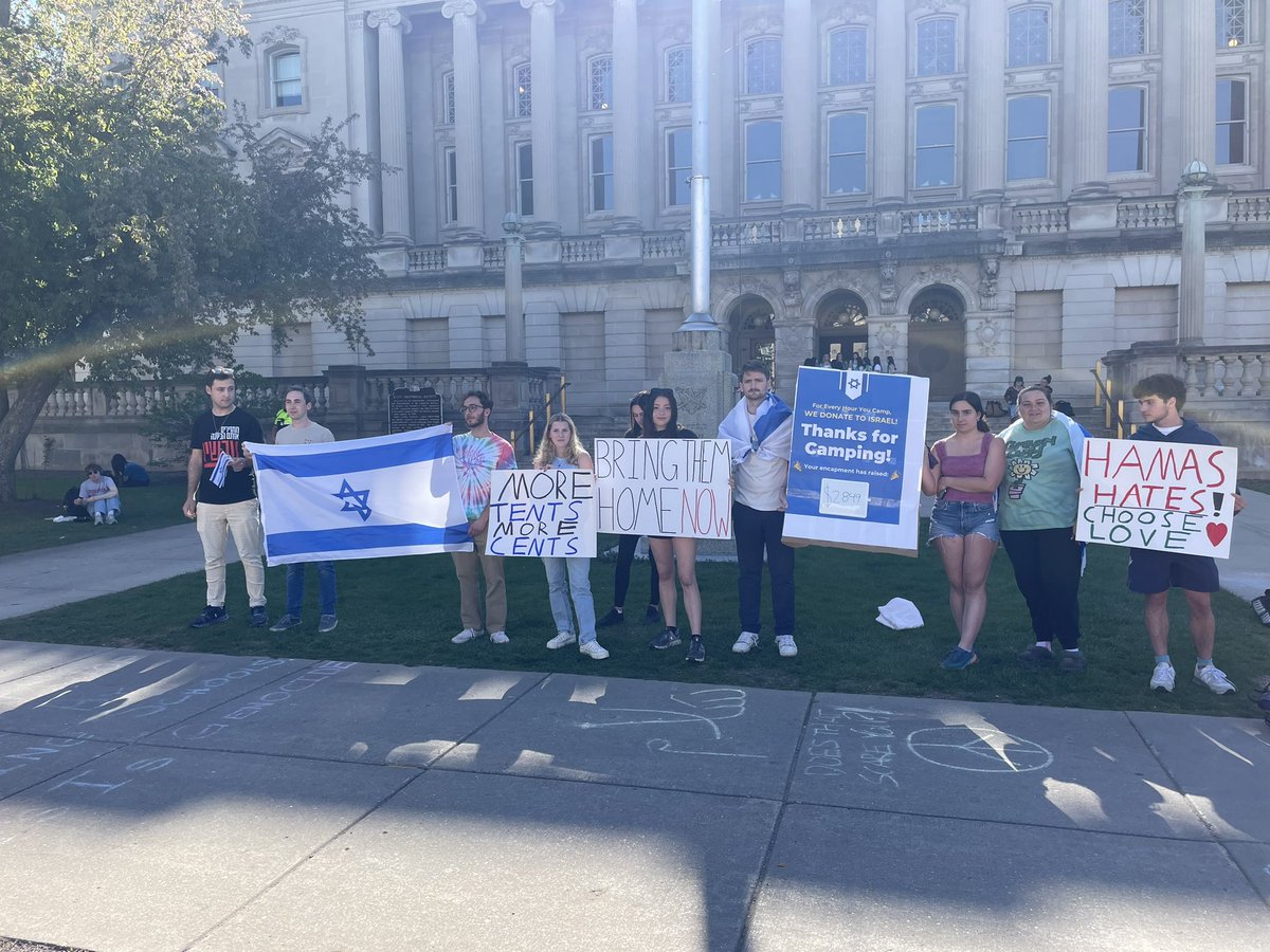 Happening now on Library Mall across from the encampment: pro-Israel students hold a counter demonstration with signs about the hostages and their donation campaign. For every hour the encampment stands, they plan to donate to Israel.