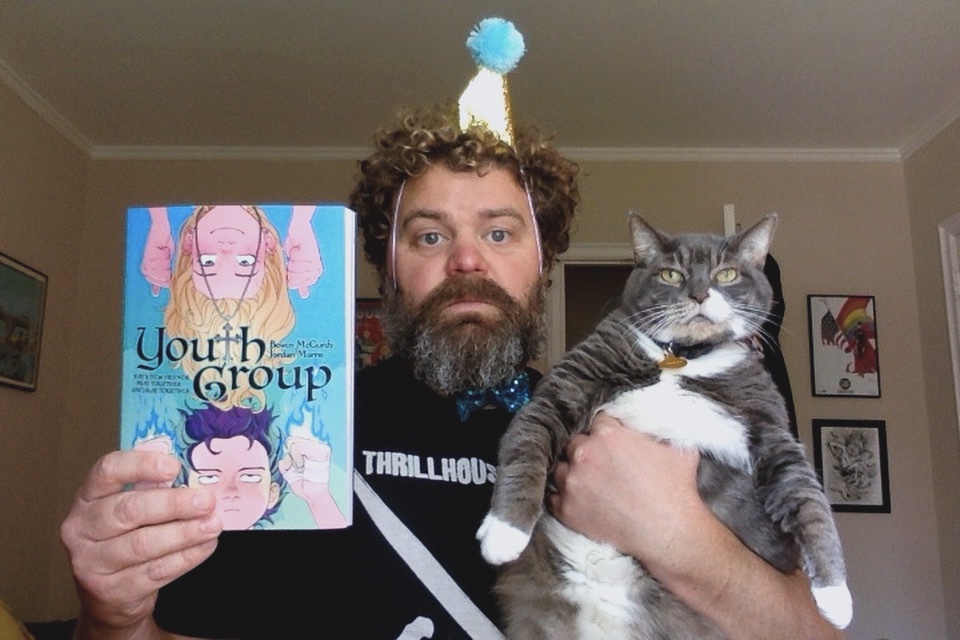 Well, this birthday is already off to a rocky start. The cat refused to wear the party hat/tie I got her so I guess I have to do it! You can help salvage this birthday by pre-ordering “Youth Group,” the upcoming graphic novel from me n’ @bonesbunns! Links in bio!