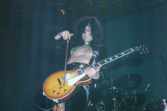 Jimmy Page playing his guitar with a violin bow, 1970s.