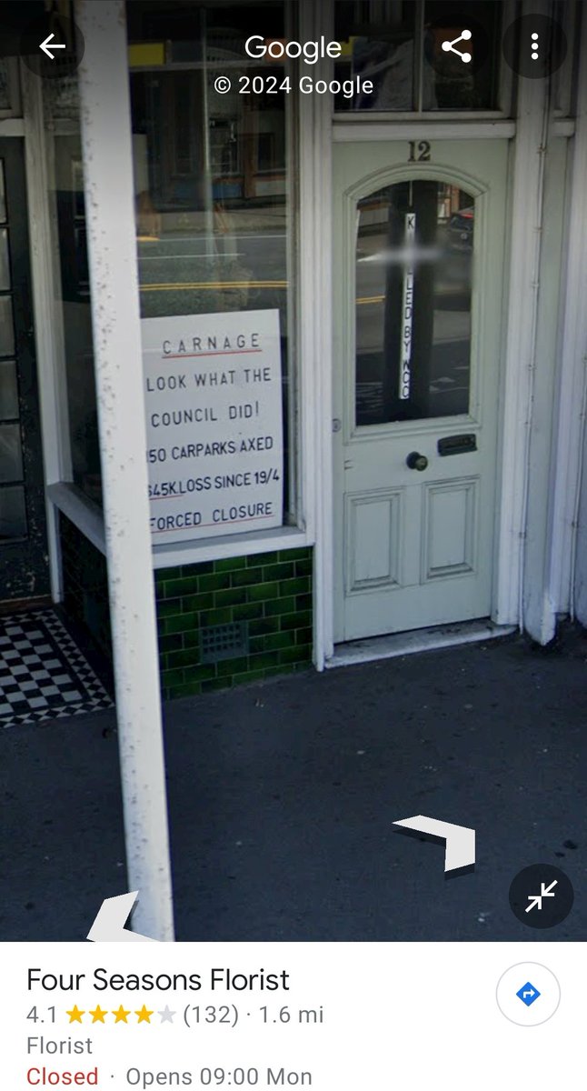 Sign on the window of Four Seasons Florist on Google maps. Unsure of the date of this photo, but there hasn't been parking outside that building for decades.