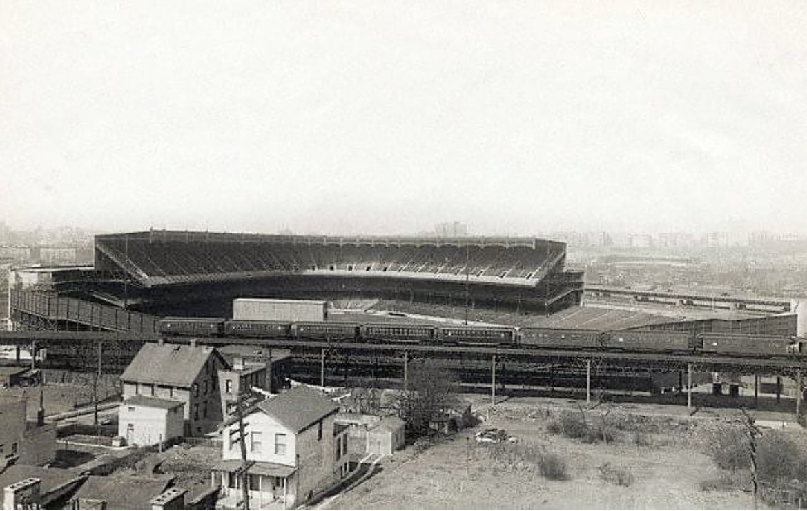 Old Yankee stadium when it opened. If you squint you can see Polo Grounds across the Harlem River. Pretty cool historical photograph.