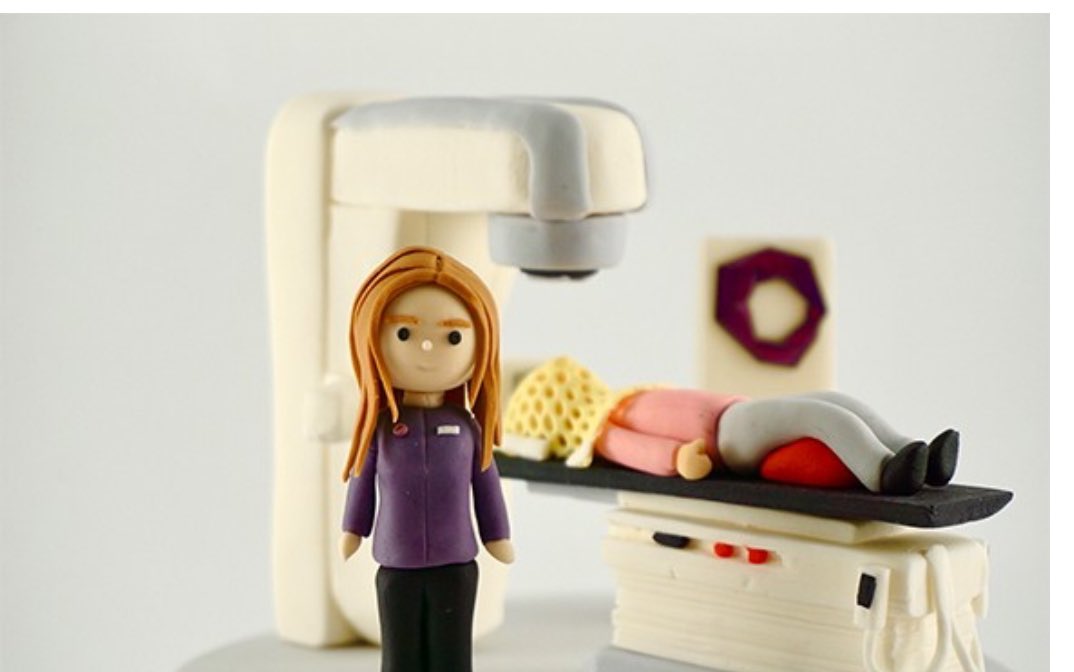JulieMcCrossin's tweet photo. A prize-winning cake from the #LINACBakeOff competition. This cake model of a radiation therapy machine was made by Dr Tsien Fua, radiation oncologist at @PeterMacCC The bakeoff encouraged cancer teams to use models to educate patients & families about what to expect in treatment. The mask is worn to keep your head still so the radiation hits the rumour precisely & keeps damage to healthy tissue to a minimum. #ESTRO2024 #rtt #radonc #mesphys
