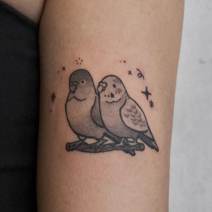 custom design of a pair of adorable birds for shannon's first tattoo!  books open