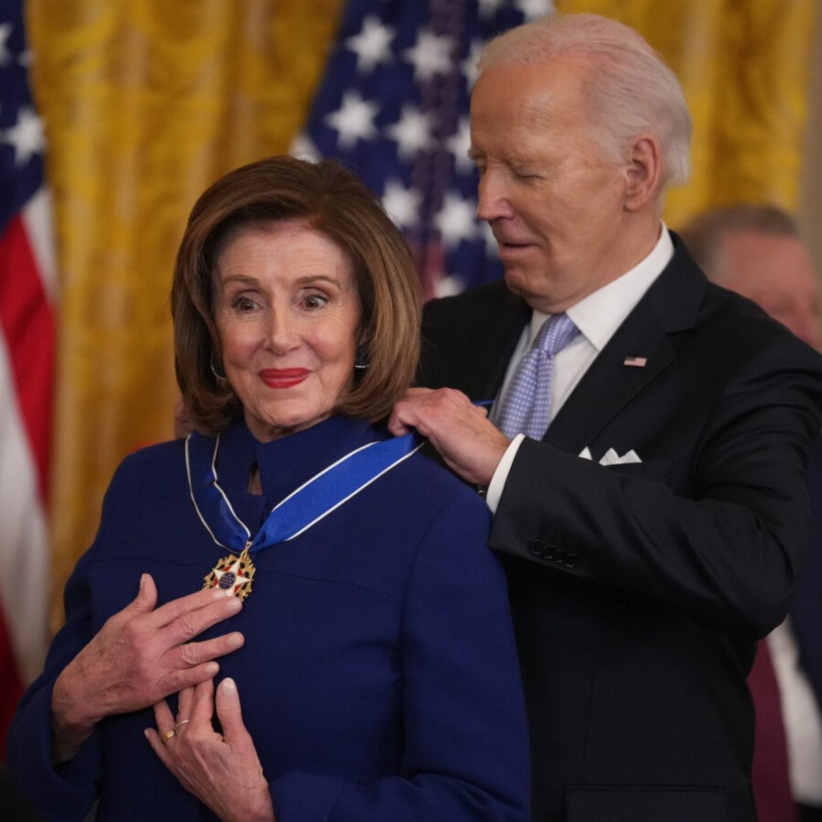 Joe Biden awards Nancy Pelosi the medal for Greatest Insider Trader of All Time.