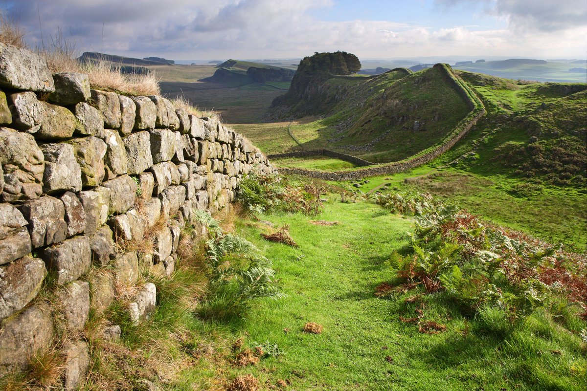 Hadrians Wall trails away into the distant landscape. 77 miles. England. NMP.