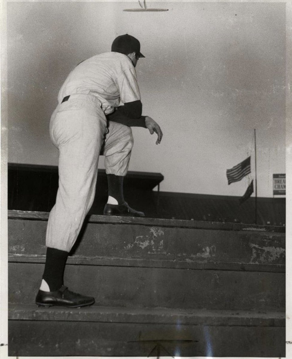 Joe DiMaggio looking at the flag at half mast in honour of Lou Gehrig