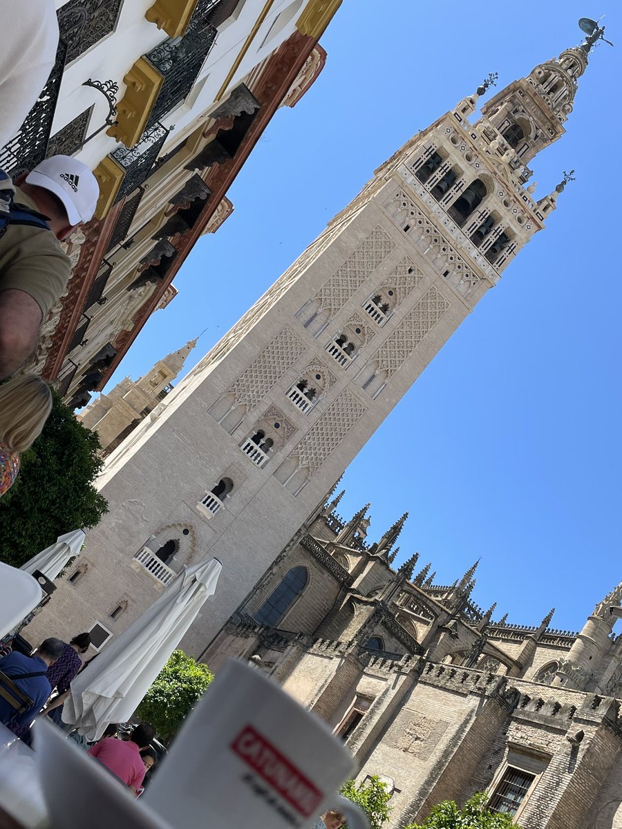 A powerful cortado at the base of the Almohad minaret tower of the Great Mosque and now belltower of the Cathedral: La Giralda here in Seville. Far too hot to climb