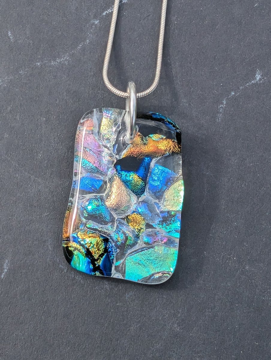 A unique ethereal and ghostly dichroic glass necklace. Stunning array of colours within this unique pendant. #ukgiftam #ukgifthour #handmade #etsy #giftideas #shopindie #etsyuk #jewellery buff.ly/4b0LdwM