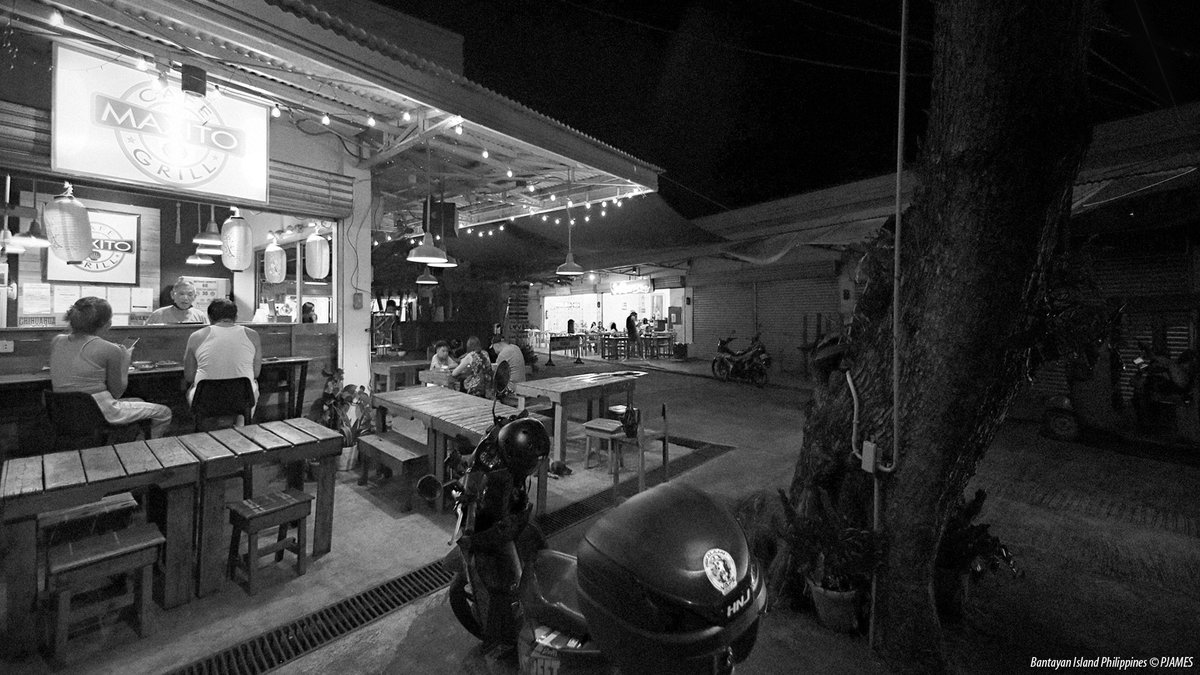 Island Life Therapy: 7pm late night at the food court, enjoying a fresh evening breeze in Santa Fe - Bantayan Island Cebu, The Philippines. #ThePhotoHour #travelphotography #IslandLife #bantayanisland #bantayan #StormHour #ShotOnCanon #blackandwhitephoto #streetphotography