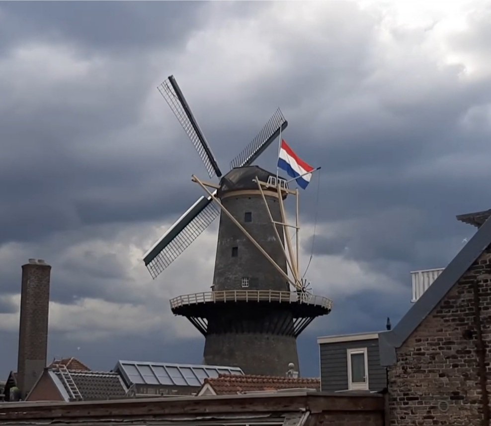 The #Windmill named #Freedom in 1785 remembering the victims of war with the #Dutch national flag halfmast. 
A #thunderstorm brewing in the background.
#Molen de #Vrijheid #Schiedam #Holland #TheNetherlands 
#4mei #Dodenherdenking #RemembranceDay