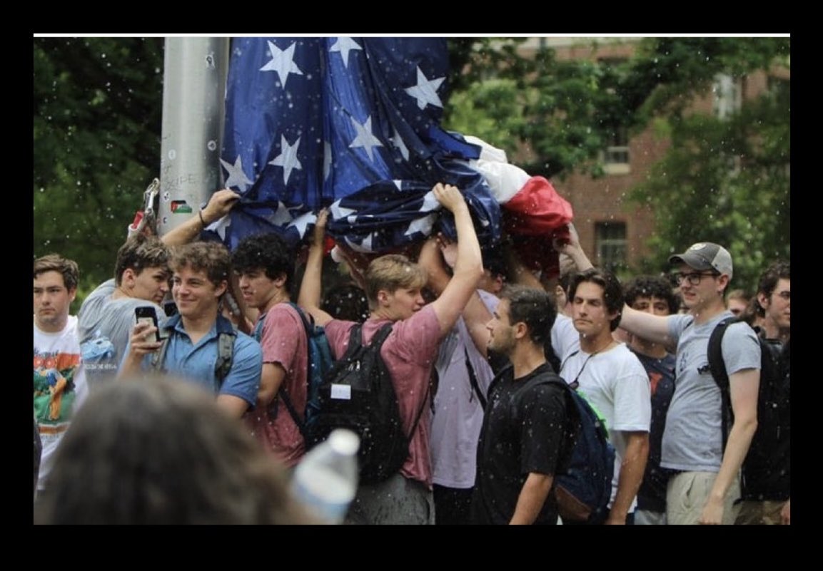 This photo gives me hope for the future. God bless the patriotic, young men of UNC for defending our flag. Our country exists because of people like them.