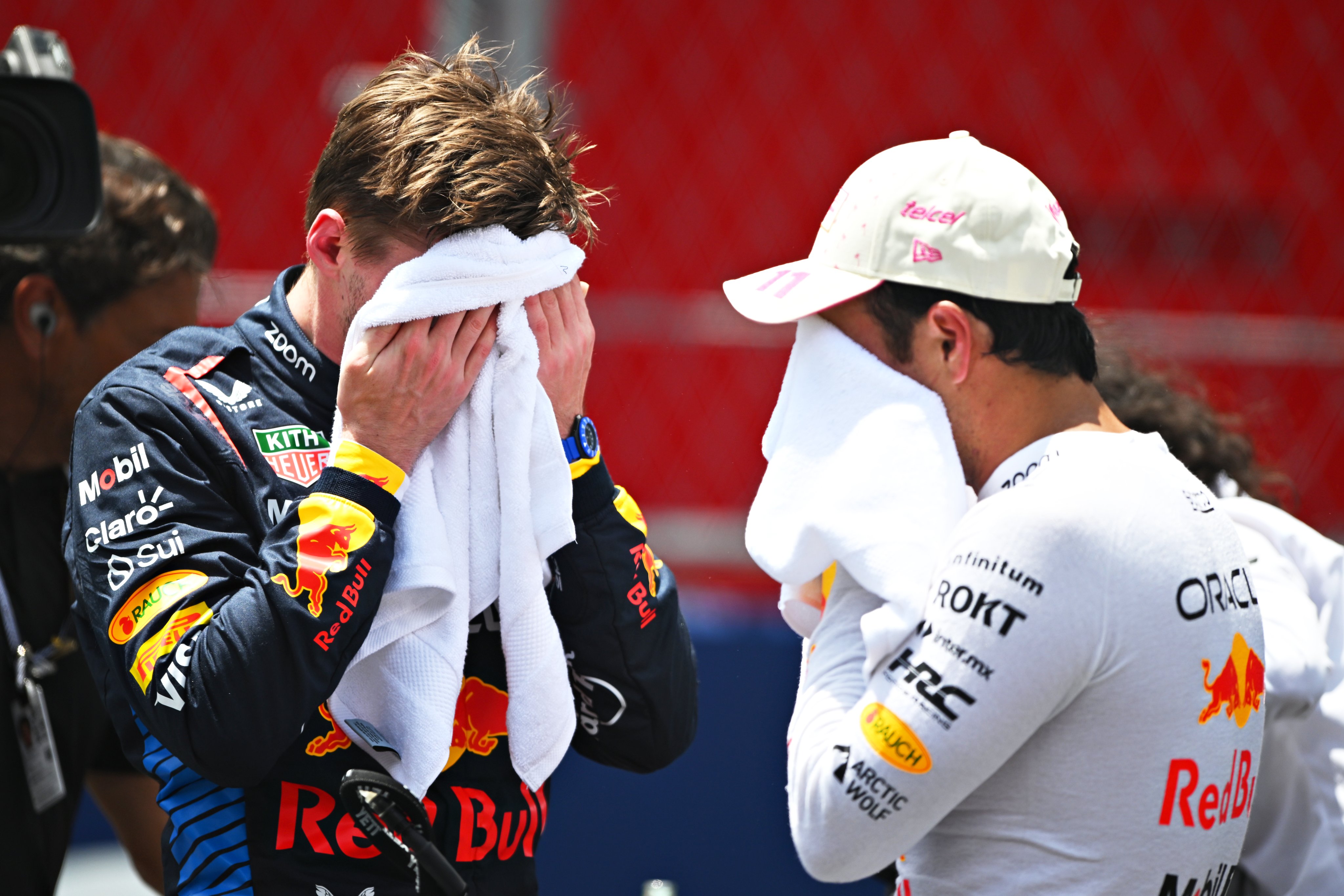 Max Verstappen and Checo Perez bury their faces into towels after the 2024 Miami GP Sprint.