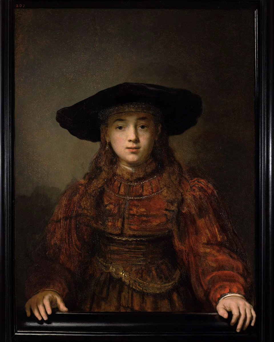 Girl in a picture frame by Rembrandt. 
The girl puts her hands out of the painting on the painted frame. Trompe l'oeil, eye deceiving! By turning her slightly to the left, R increases the illusion of movement.