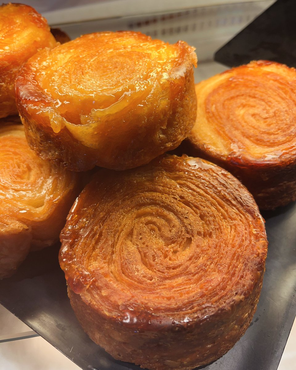 Kouign Amann is a pastry from Brittany, France. In Breton language, it literally means ‘butter cake’. (cake - kouign and butter - amann) ​It originated in the town of Douarnenez and the baker Yves-Rene Scordia is believed to have ‘invented’ it in 1860
