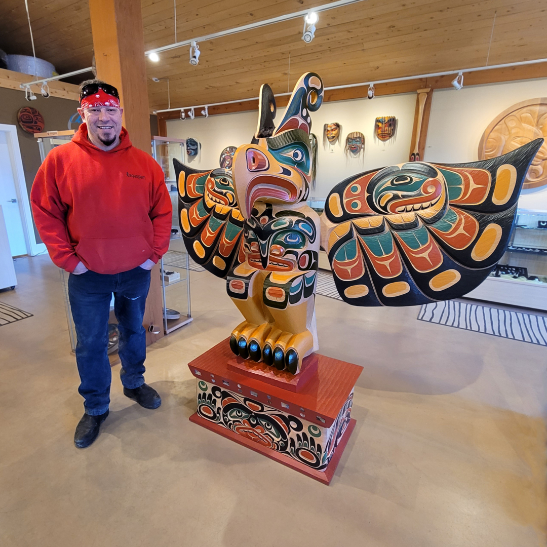 This Guardian of the Gildas Totem Pole was created by Kwakwaka'wakw carver Junior Henderson. The carving depicts the Thunderbird with the Orca crest carved into the chest and wings. The Thunderbird stands atop an enclosed box with a Sisuitl carved into it.
