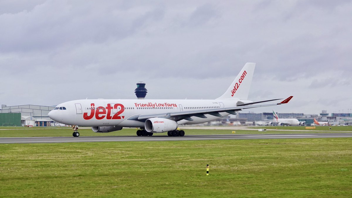 A wide Shot Of AirTanker G-VYGK Airbus A330-243 Jet2 Ops Rolls Off Runway 23L Manchester Airport MAN Flight LS917 To Tenerife TFS On 05/04/2024.