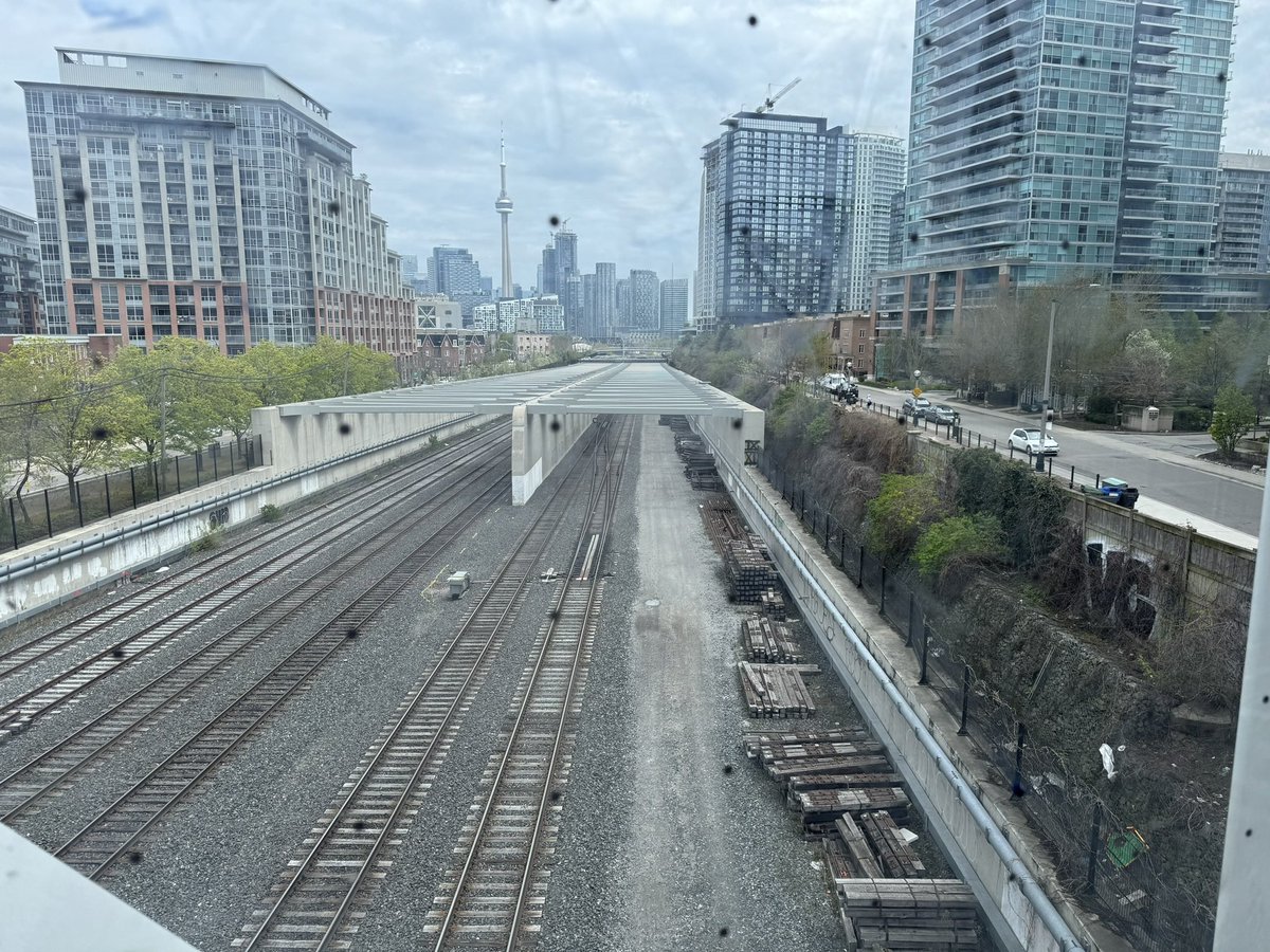 What if tracks had been lowered a bit more and instead of the scaffold top. It has been made into a full tunnel with park on top. And of course allowed more pedestrian and bike access between Liberty Village and King Street West. 

Short term cost savings, but life long impact.