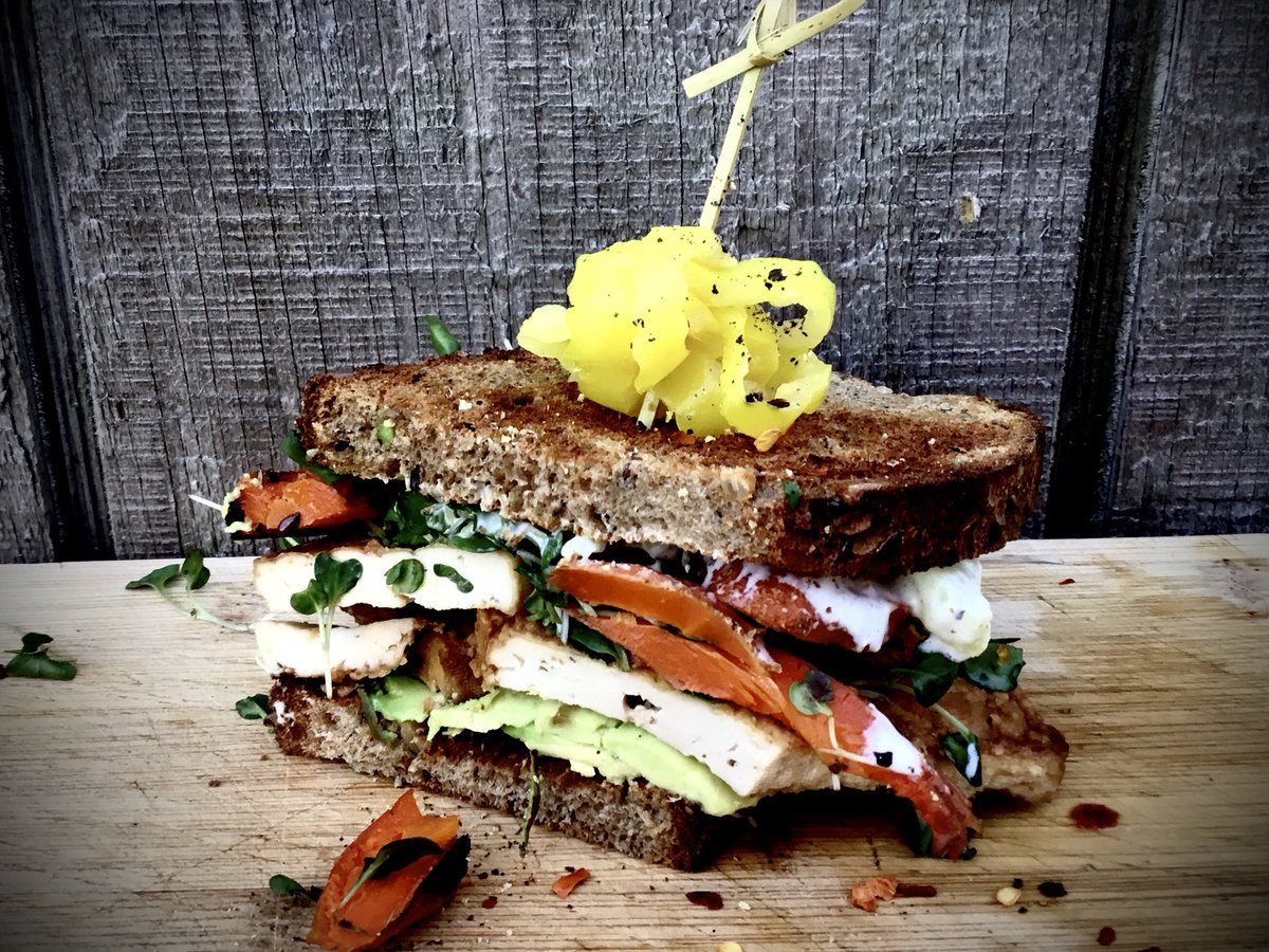 🍴SESAME GARLIC BAKED TOFU SANDWICH W/FRESH AVOCADO AND TENDER ROSEMARY ROASTED CARROT ON ORGANIC SEEDED MULTIGRAIN WITH CRISP MICROGREENS AND A CREAMY LEMON AIOLI.. GARNISHED WITH SLICED BANANA PEPPERS..DELICIOUS❤️🍴…VISIT CALLICOON KITCHEN ON INSTAGRAM