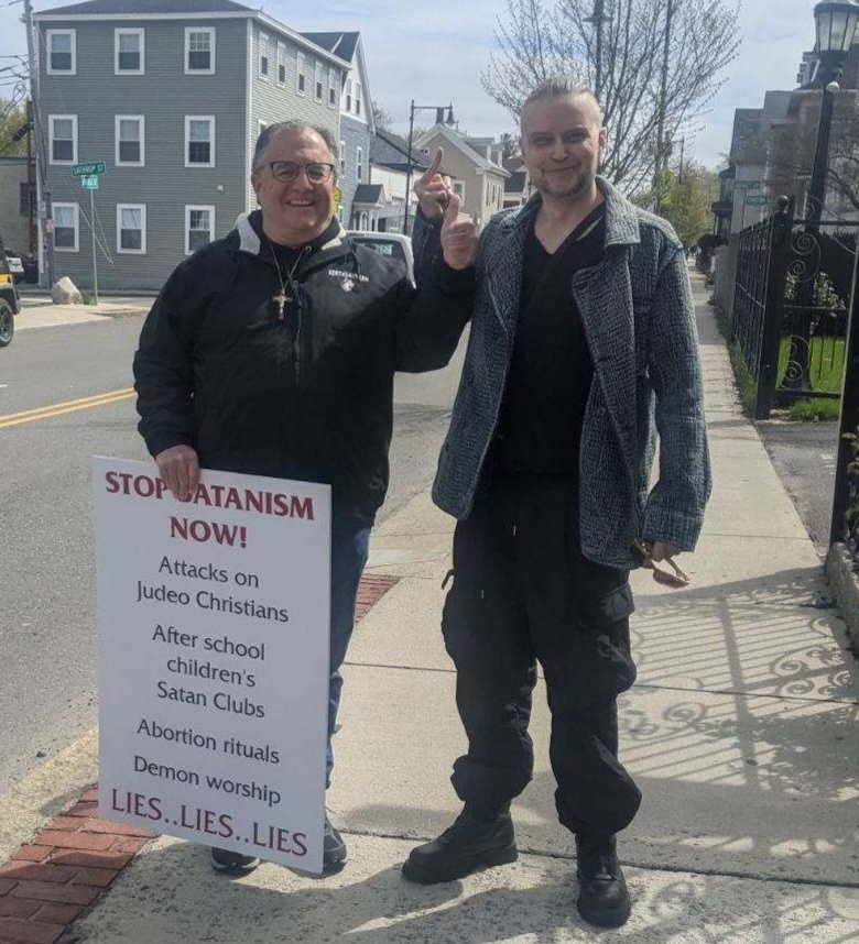 Politely showing my middle finger to a happily accepting visitor outside The Satanic Temple headquarters in Salem, MA.