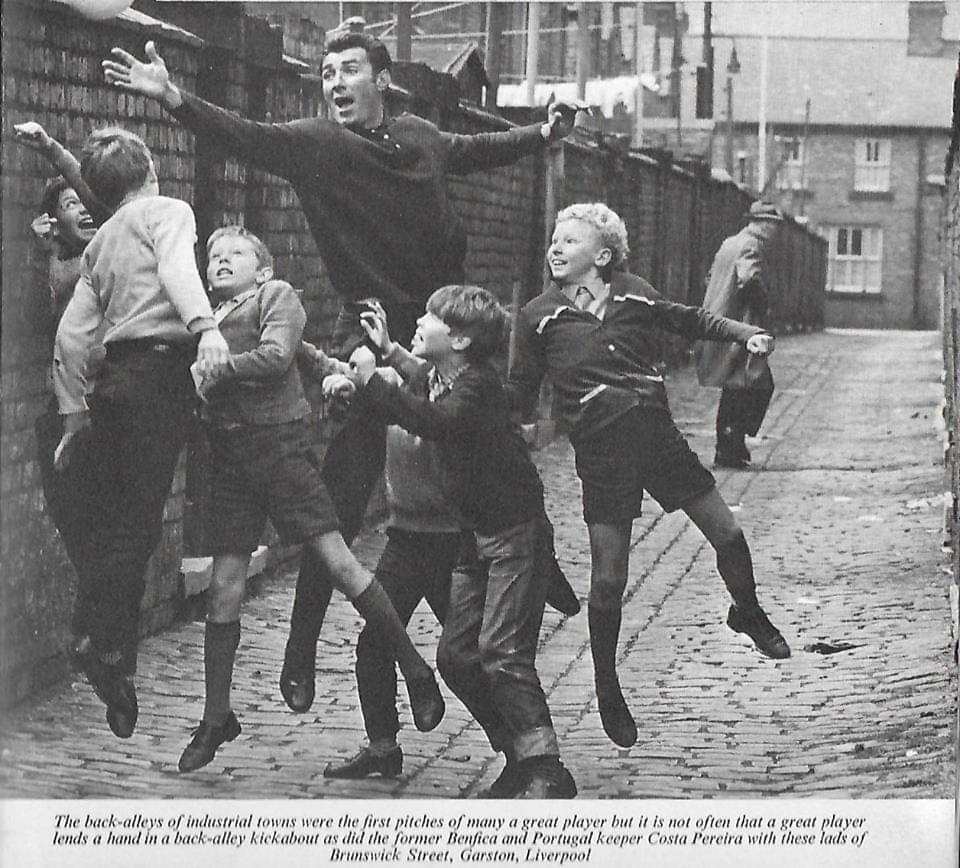 Costa Pereira, the Benfica and Portugal international goalkeeper, playing football with the kids of Brunswick Street, Garston, during his trip to England to play at Holly Park in the Bankfield House charity match, 1968.