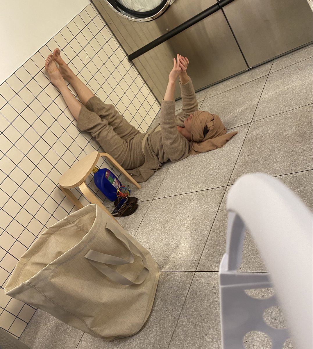 Just a rainy day at the laundromat with someone doing their yoga… wait… what? 😳